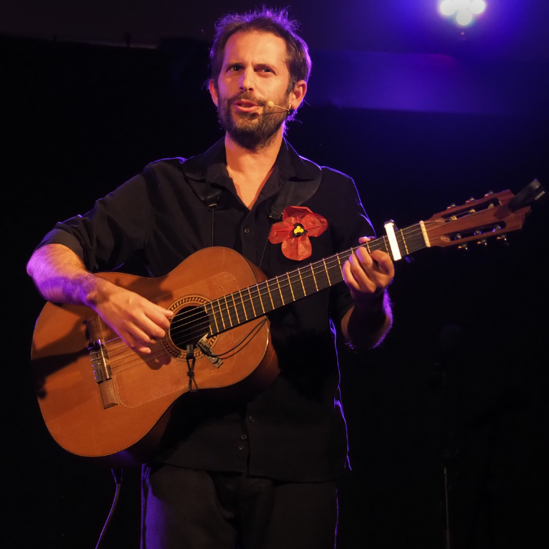 Norbert Gautier interprète à la guitare et au chant la chanson "Mariette et François" lors du spectacle "Chansons & Coquelicots", hommage à Anne Sylvestre.